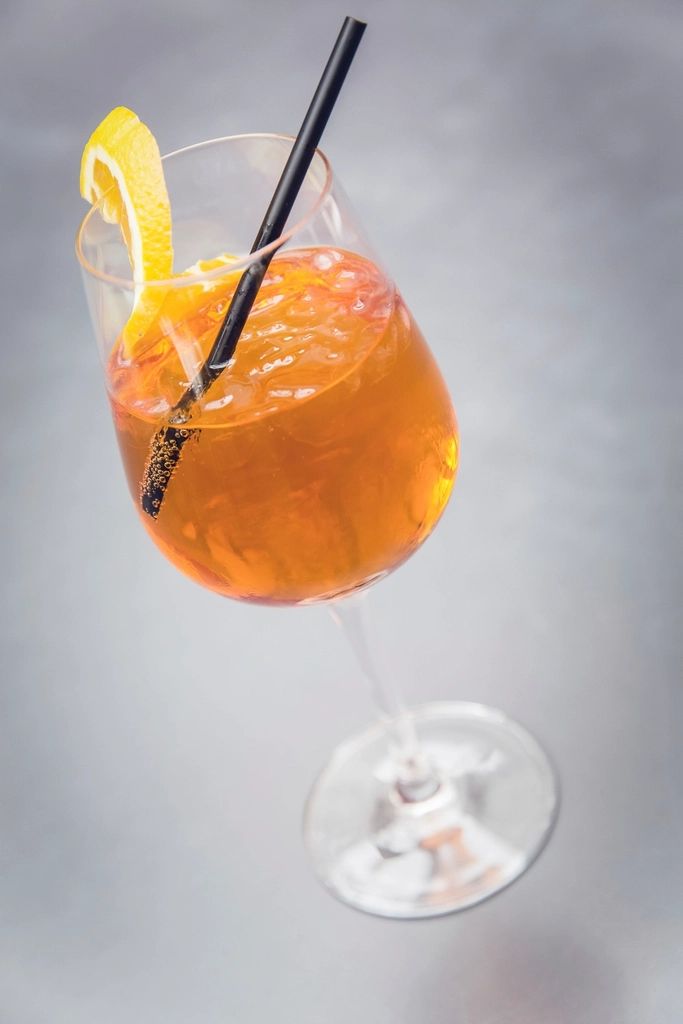 A cocktail being finished at the bar