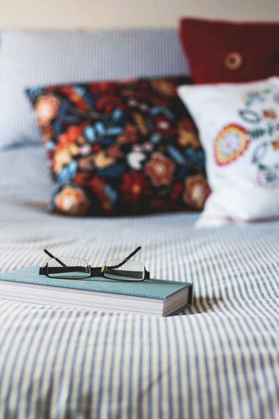 A guest room with a large bed and soft lighting