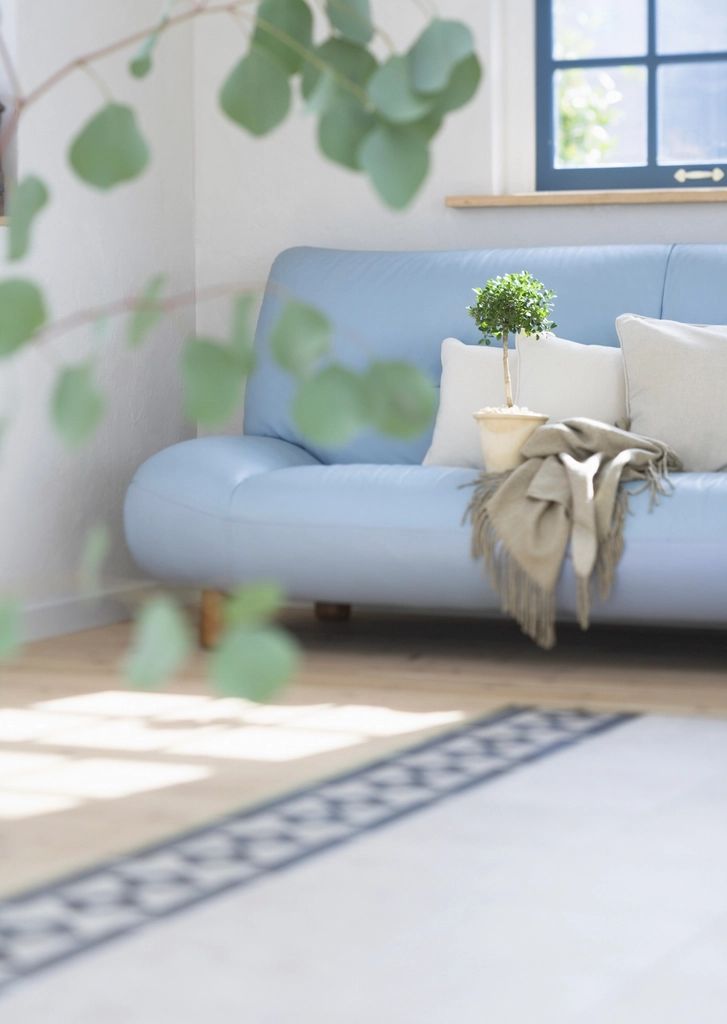 A suite sitting room with a sofa and armchairs